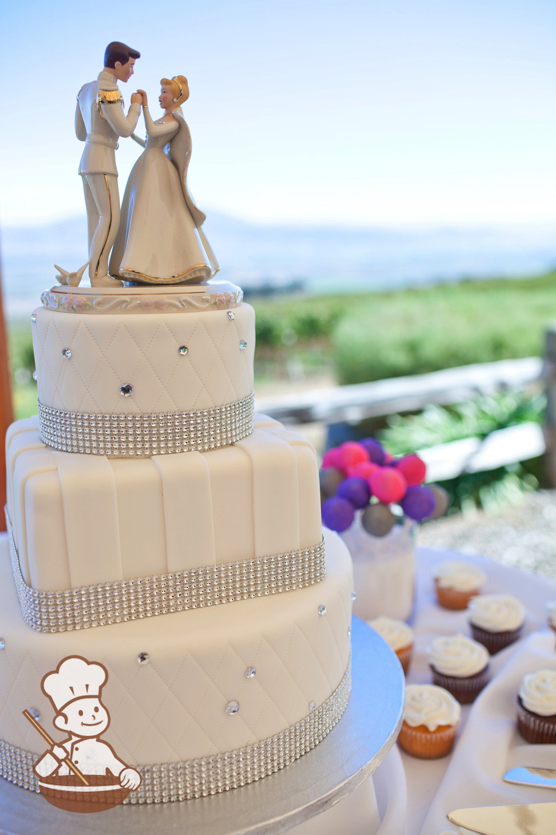 3 tier round and square fondant wedding cake with vertical fondant stripes, quilted patterns and rhinestone decoration.