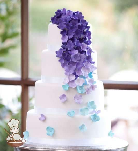4 tier fondant wedding cake with cascading sugar hydrangeas from purple to baby blue colors.