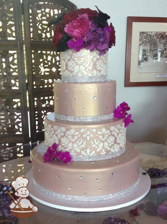 4 tier champagne colored fondant cake with vintage white design and rhinestone band wrap.