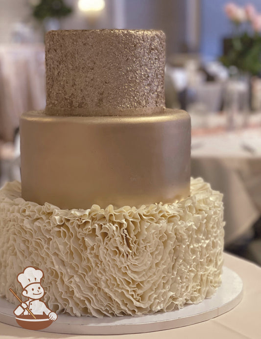 Fondant covered wedding cake with textured top, smooth middle and think fondant floral ruffle pattern. Top 2 tiers are painted in champagne gold.