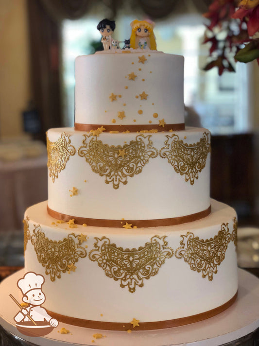 3-tier cake with smooth white icing and decorated with gold lace draping, a thin gold ribbon on the base of each tier and yellow fondant stars.