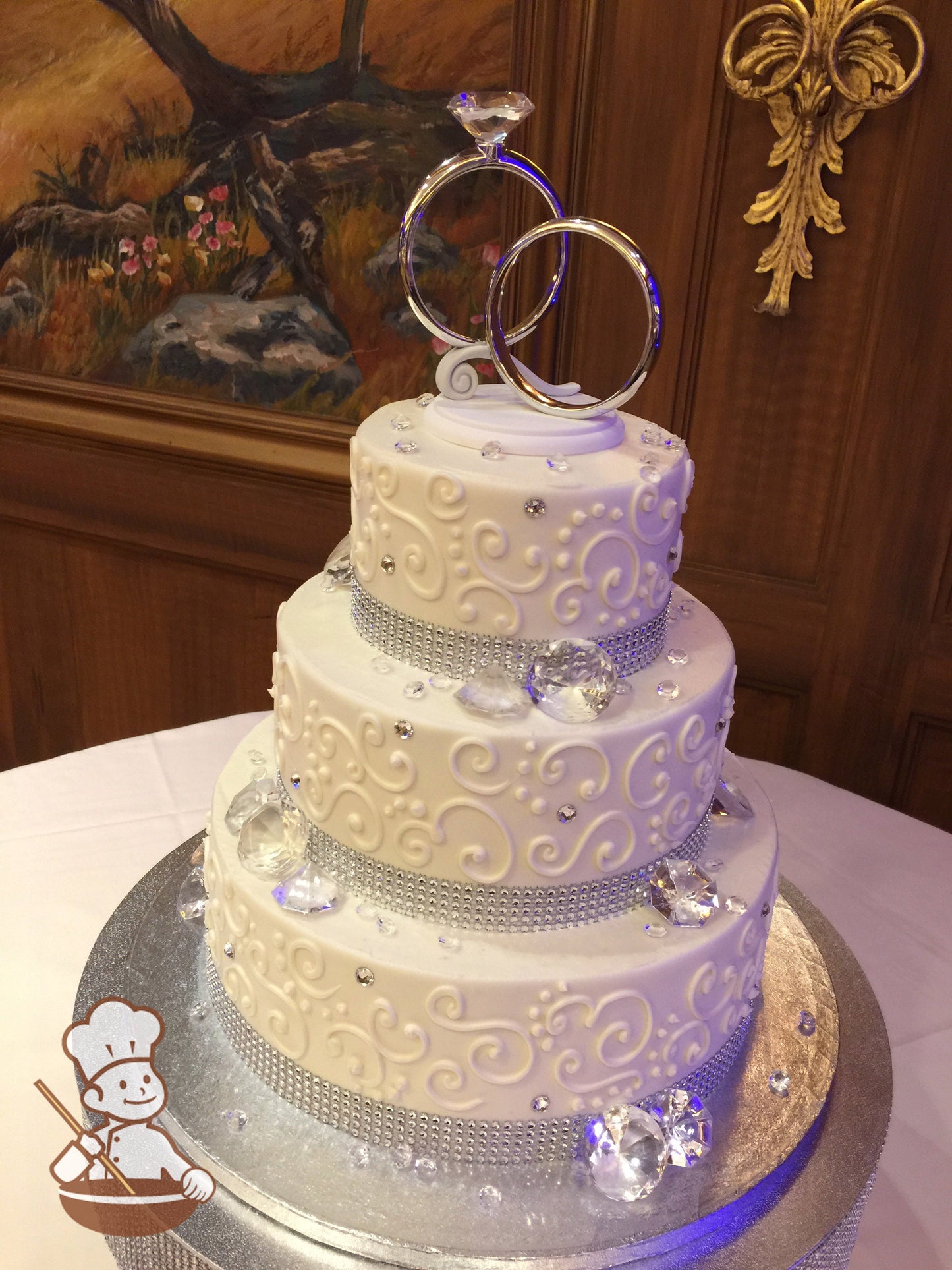 3-tier cake with rhinestone band, plastic diamonds and hand piped scrolls.