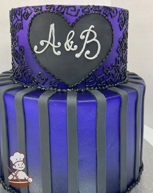 2-tier dark purple cake with black square swirls, and with white initials inside a heart frame. Bottom tier with black fondant vertical strips.
