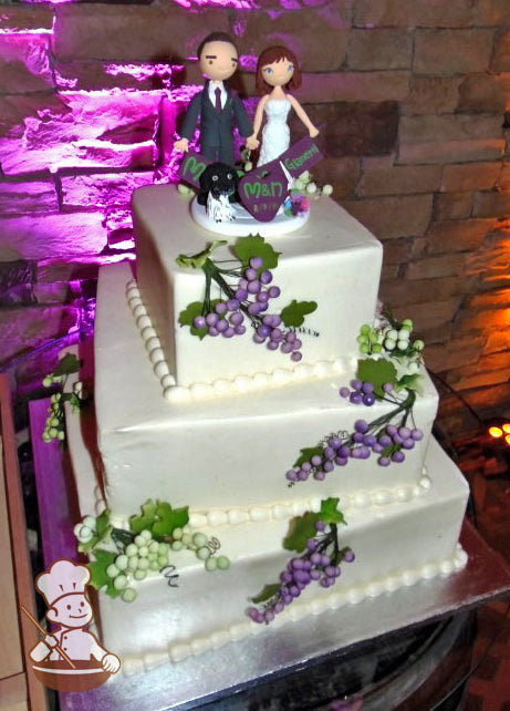 3-tier off-set white square cake with green and purple grape clusters.