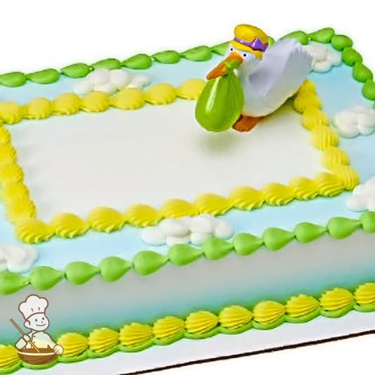 Baby shower sheet cake with toy stork carrying baby.