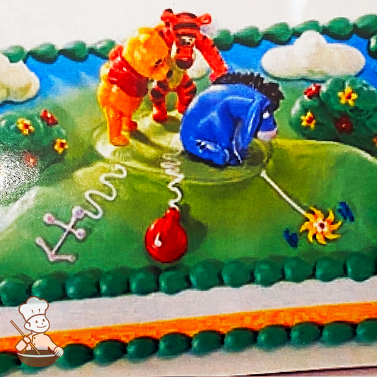 Birthday sheet cake with buttercream hill and garden with Winnie the Pooh, Tigger, and Eeyore toy set.