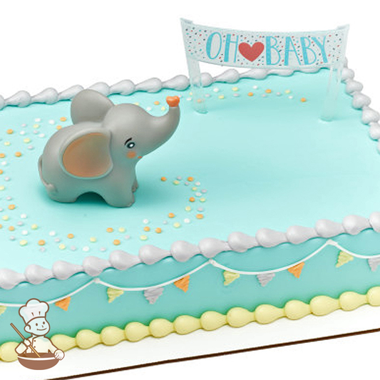 Baby shower sheet cake with toy elephant and Oh Baby banner.