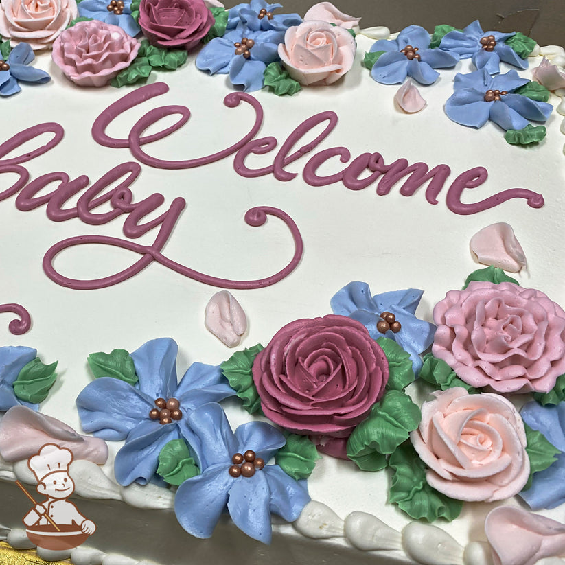 Sheet cake with white buttercream frosting, decorated with pink and blue buttercream flowers, green leaves, and pearl accents.