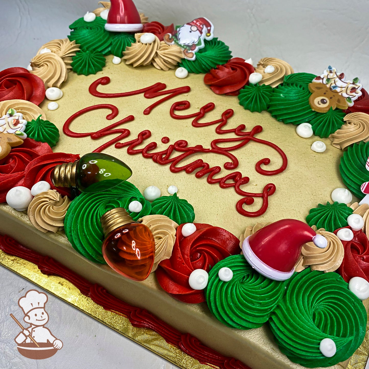 Sheet cake with buttercream rosettes in red, green, and beige, white buttercream pearl accents, plastic holiday toy rings decorations.