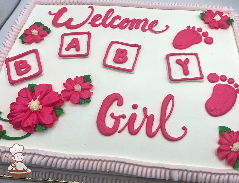 Sheet cake with pink buttercream baby blocks, footprints, and flowers, featuring ruffle trim edges. Decorations include vibrant pink blossoms with green leaves.