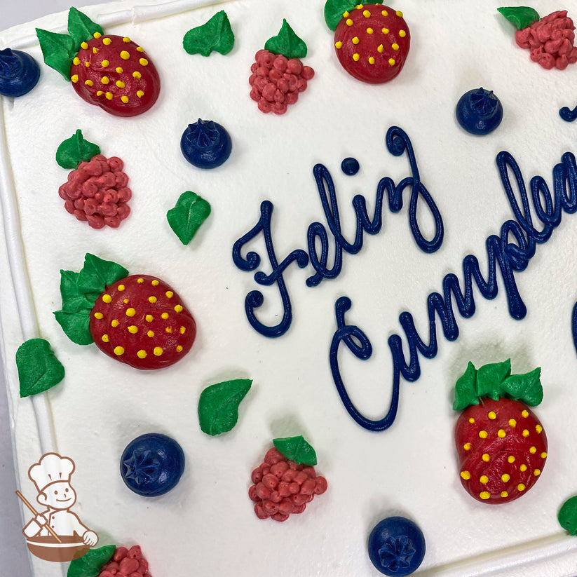 Sheet cake with white icing, decorated with buttercream strawberries, raspberries, blueberries, and green leaves.