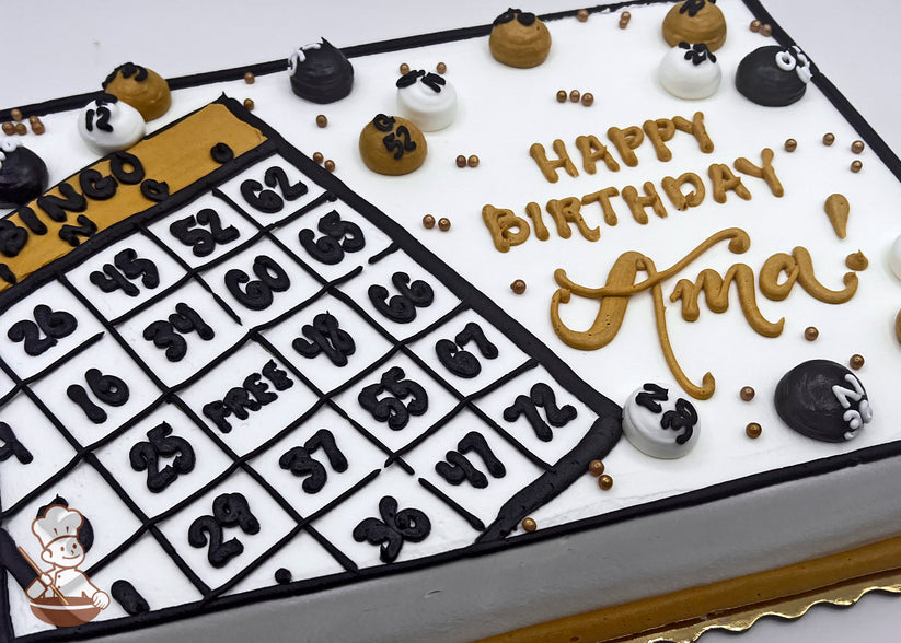 Sheet cake with buttercream bingo card and balls, decorated in black, white, and gold. Gold, black and white buttercream dots scattered around.