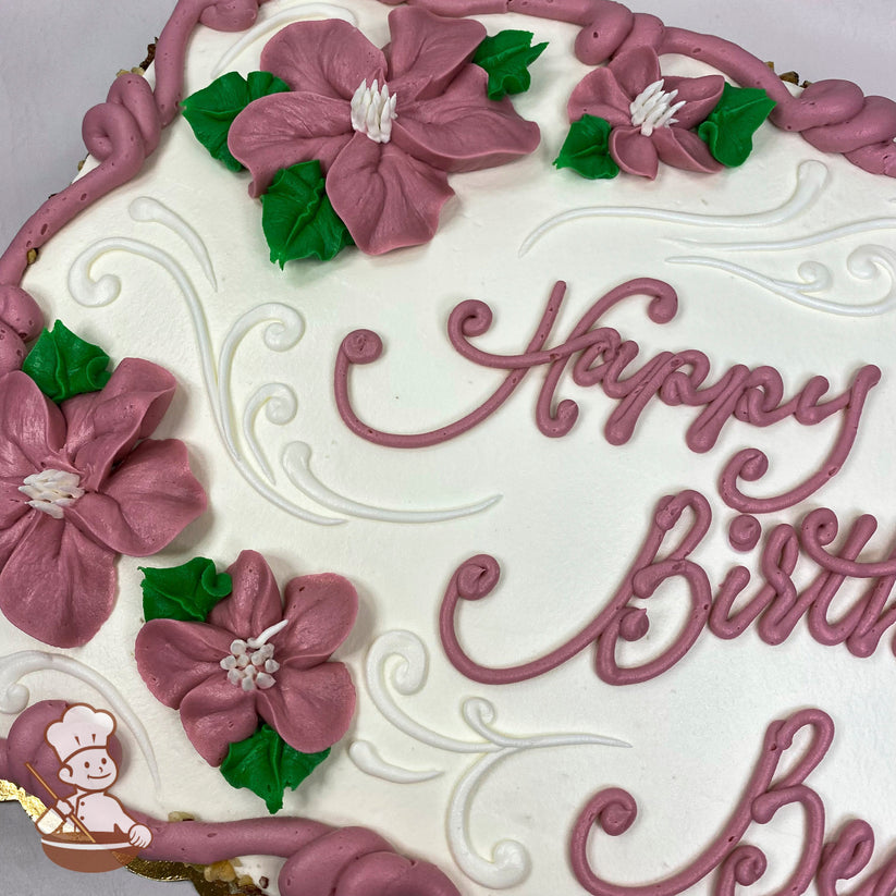 Sheet cake with pink buttercream flowers, green leaves, and elegant white scrolls.
