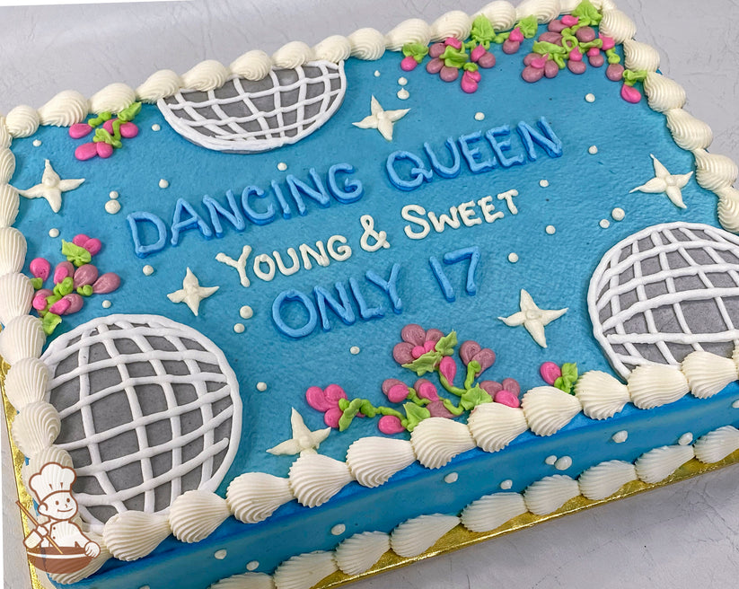 Blue sheet cake with buttercream disco balls, white stars, mini pink flowers, and a white piped border.
