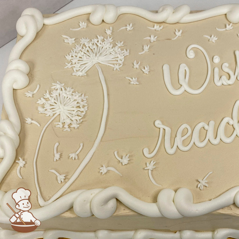 Sheet cake with beige icing, decorated with hand-piped white dandelions and seeds blowing in the wind, framed by a swirled buttercream border.