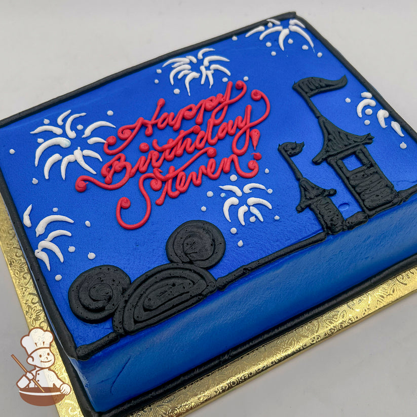 Blue sheet cake with hand-piped black castle, Mickey ears, and white fireworks. Decorated with red script writing and bordered in black frosting.