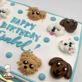 Sheet cake with buttercream dog faces, including brown and white dogs, and blue dots. Blue and green piping decorates the borders.