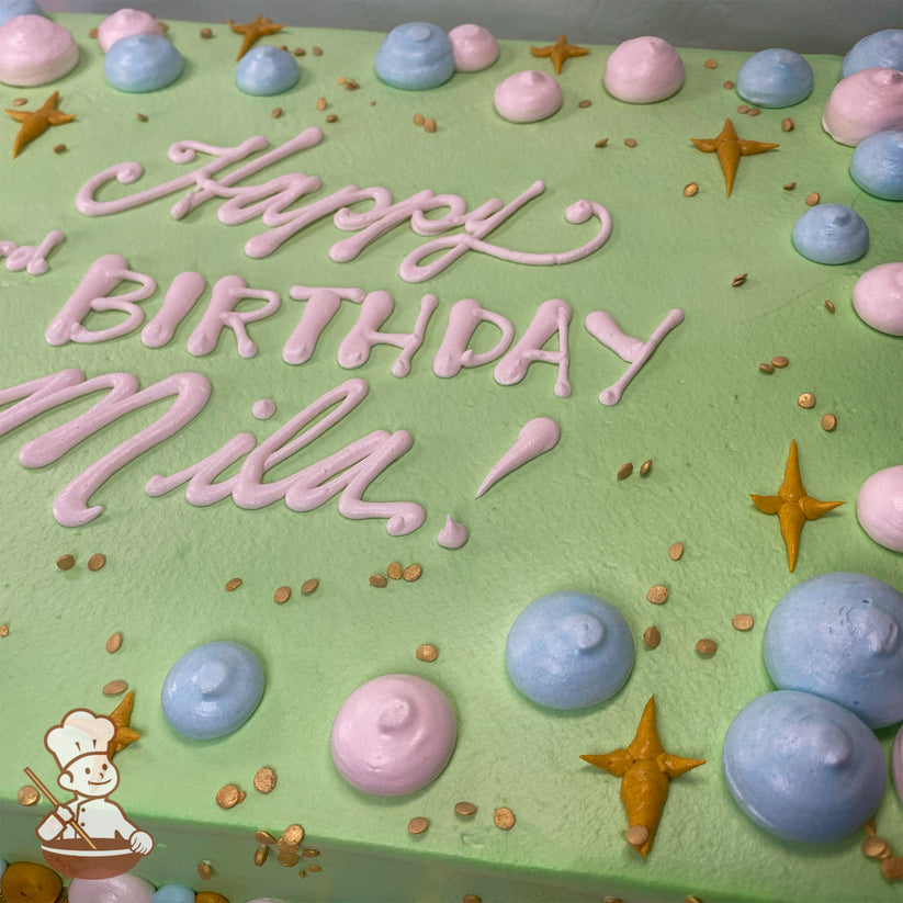 Light green sheet cake with pink and blue buttercream dollops, gold star-shaped sparkles, and small gold sprinkles scattered on top.