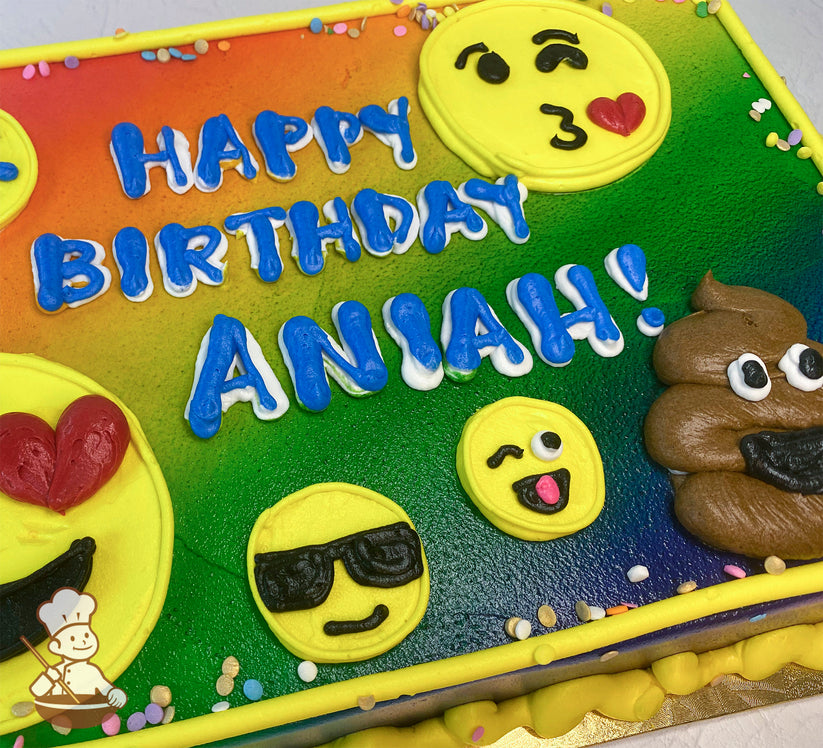 A colorful sheet cake with a rainbow gradient background, decorated with buttercream emojis: heart eyes, kiss face, sunglasses, winking face, and a poop emoji.