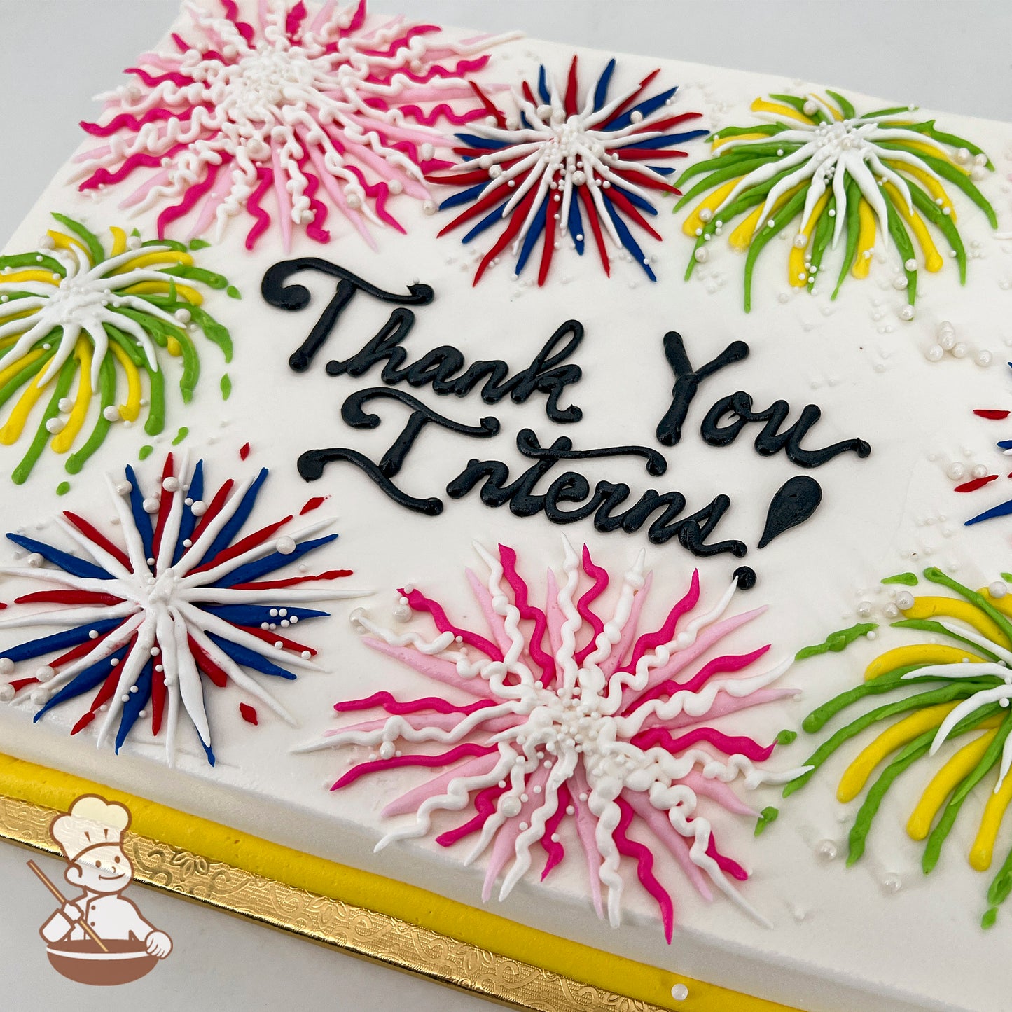 Sheet cake with colorful buttercream fireworks in pink, blue, green, and yellow.