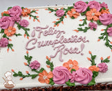 Sheet cake with white frosting, decorated with hand-piped pink rosettes, orange flowers, green vines, and leaves.