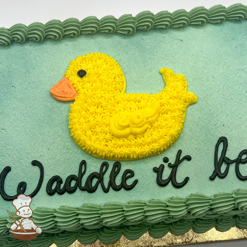 Sheet cake with light green frosting, a yellow hand-piped buttercream duck with an orange beak, and a green piped border.