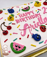Sheet cake with hand-piped buttercream fruits, including cherries, blueberries, pineapples, strawberries, and watermelon slices, surrounded by colorful sprinkles.