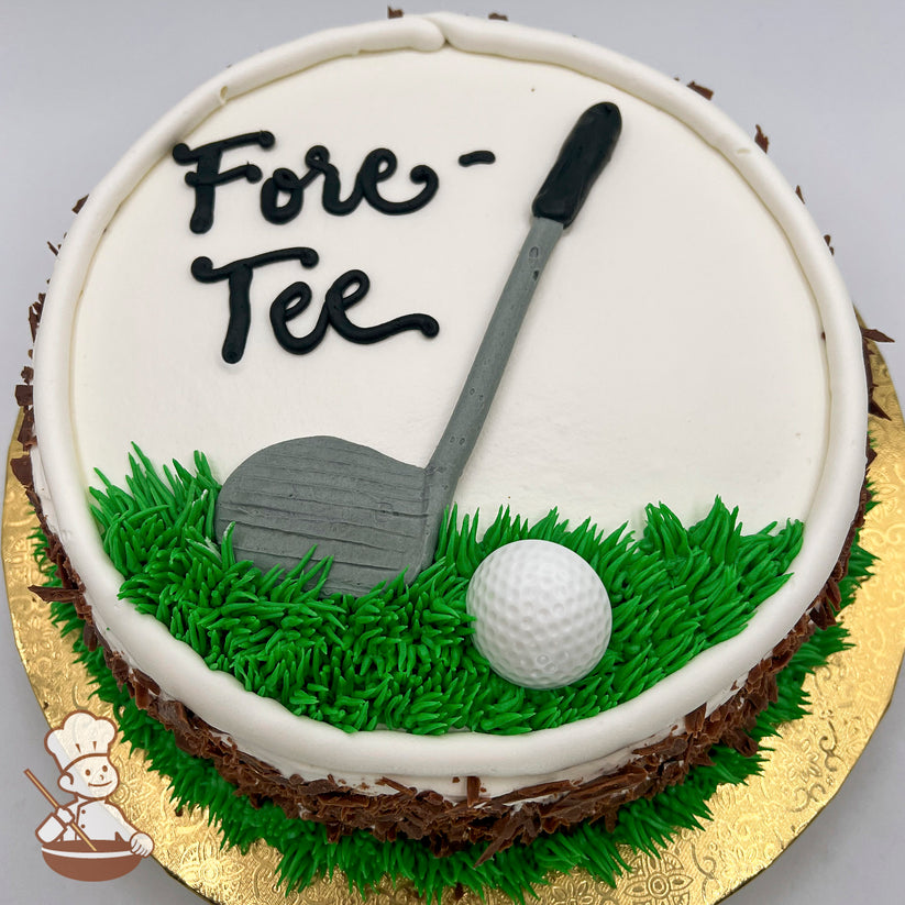 Round cake with white frosting, green grass piping, a golf club decoration, and a plastic golf ball on a gold board.