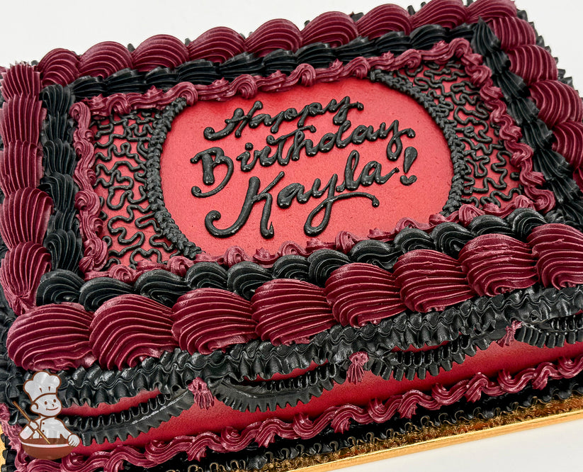 Rectangular sheet cake with deep red and black buttercream piping, featuring ornate vintage-style swirls, ruffles, and lace-like patterns.