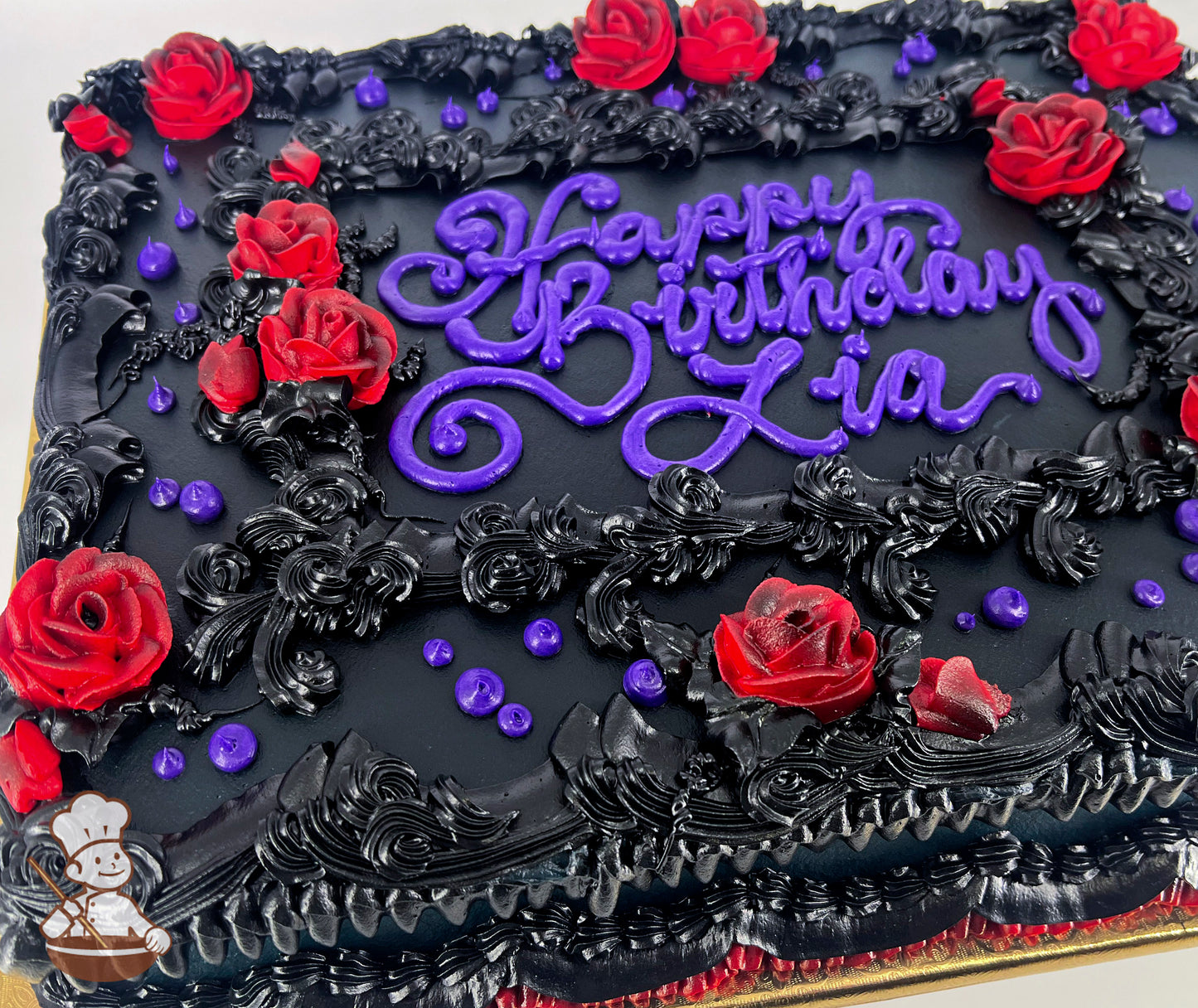 Black sheet cake with red buttercream roses, black vintage piping, and purple accents.
