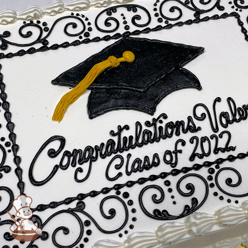 Sheet cake with white frosting, black piped scrollwork border, a black buttercream graduation cap with a yellow tassel, and decorative swirls.