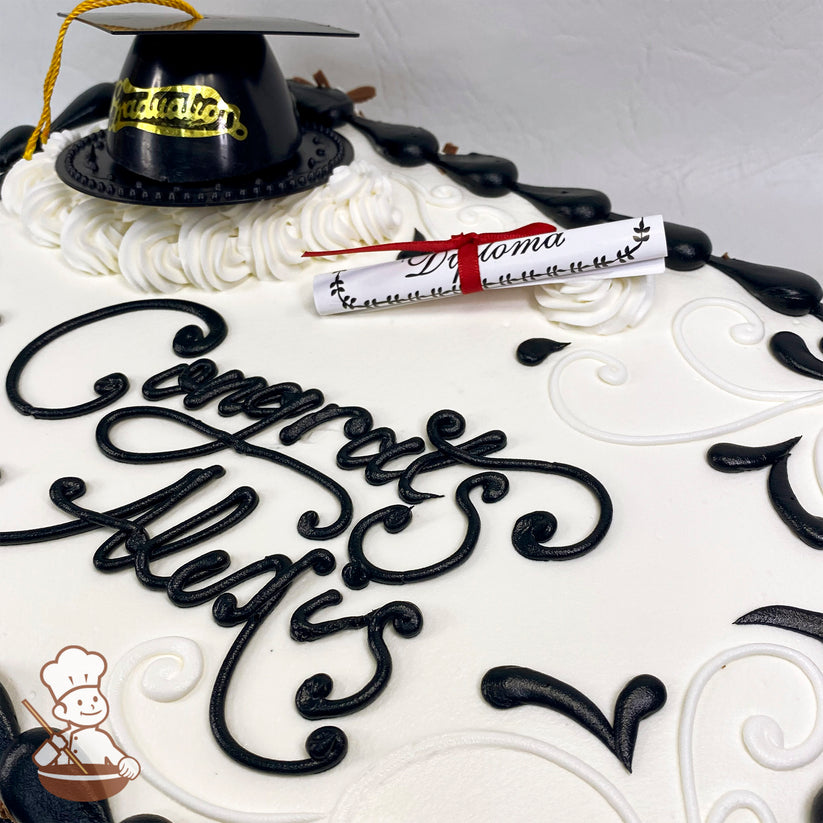 Sheet cake with white frosting, black decorative swirls, a plastic black graduation cap with a gold tassel, and a rolled paper diploma tied with a red ribbon.