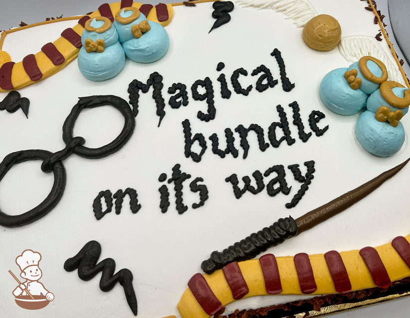 Sheet cake with buttercream decorations, including blue baby booties with golden bows, a striped Gryffindor scarf, black glasses, a wand, and a golden snitch.