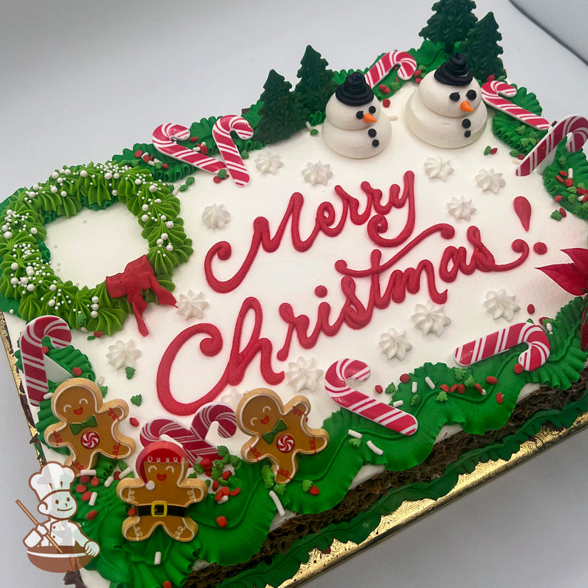 Sheet cake with green buttercream garland, candy canes, gingerbread men plastic rings, a buttercream snowman duo, and a green wreath with a red bow.