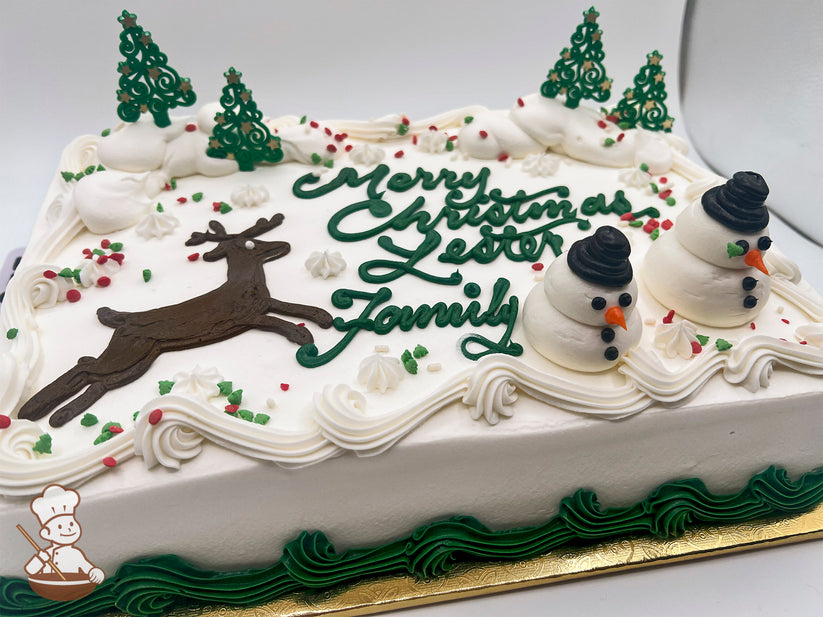 Sheet cake with buttercream snowmen, reindeer, and green plastic tree decorations. Snow-like icing and colorful sprinkles adorn the top.