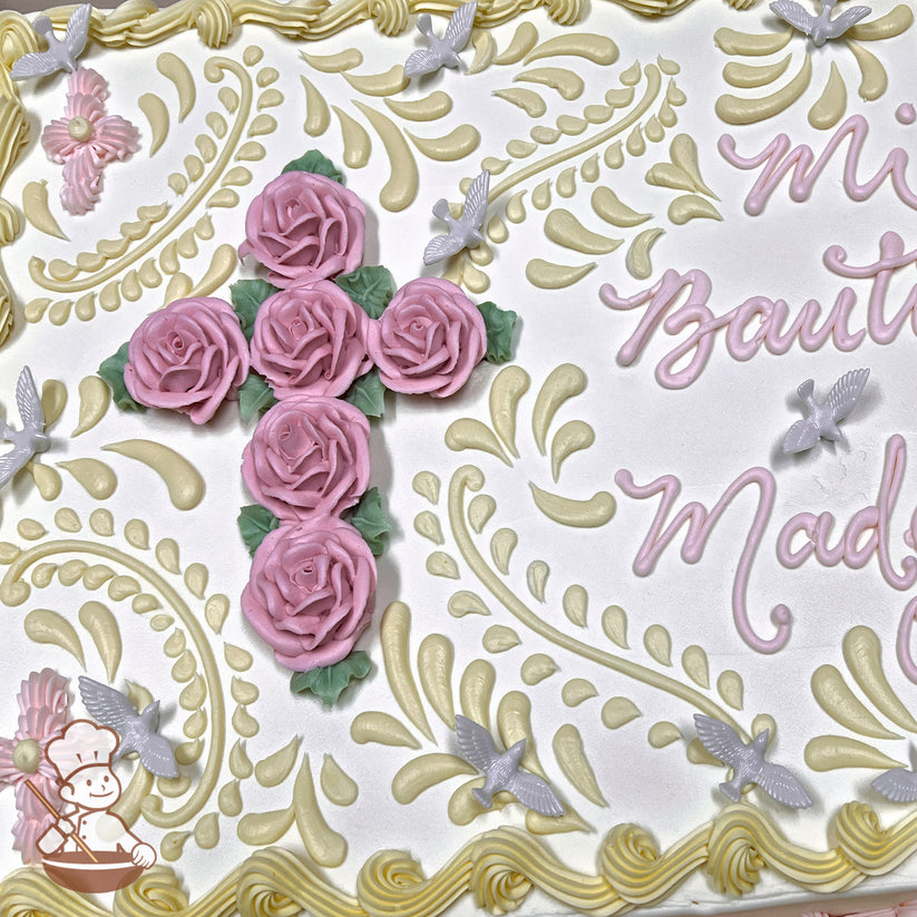 Sheet cake with buttercream decorations, featuring a cross made of pink roses, green leaves, plastic doves, and ornate yellow swirls.