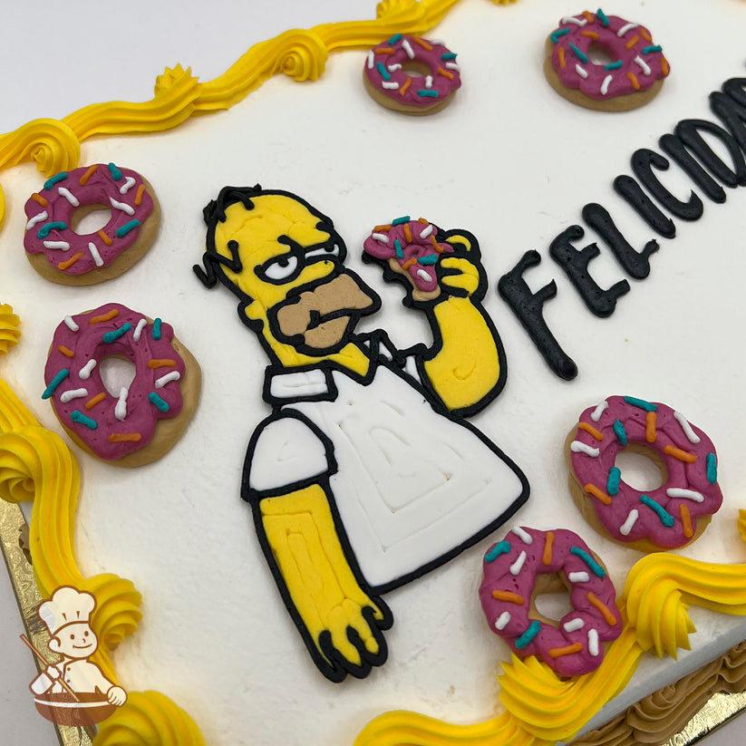 Homer Simpson made of icing holds a pink sprinkled donut on a white sheet cake, decorated with yellow buttercream trims and pink sprinkled donut designs.