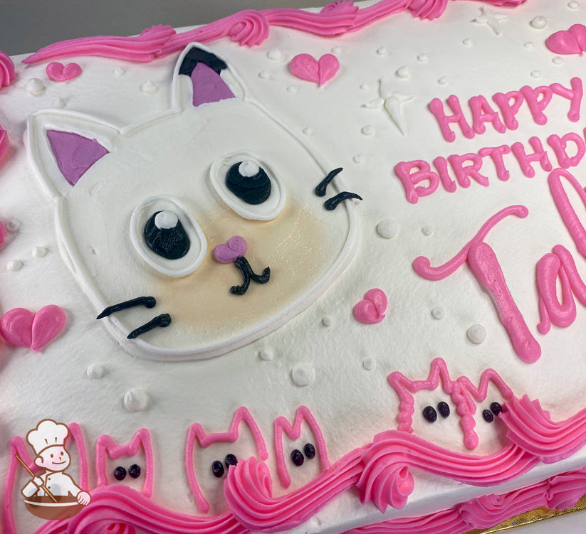 White sheet cake with a buttercream design of a Gabby's Dollhouse cat face, pink hearts, dots, and pink cat outlines along the border.