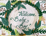 Sheet cake with white frosting, decorated with a jungle-themed frame of green leaves, vines, and small brown and floral accents.