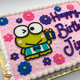 Kerokerokeroppi character in buttercream on a pink sheet cake, surrounded by colorful buttercream flowers and white dots, with a white piped border.