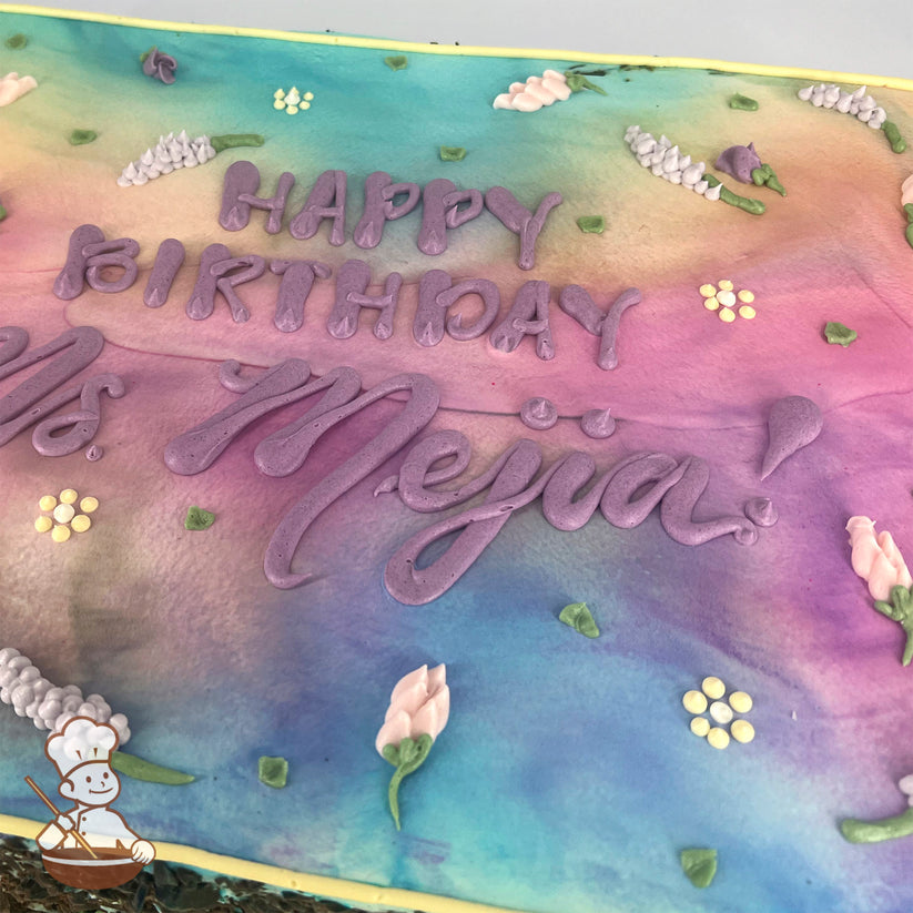 Sheet cake with a pastel gradient background of pink, purple, and blue, decorated with buttercream lavender flowers, small yellow blossoms, and green leaves.