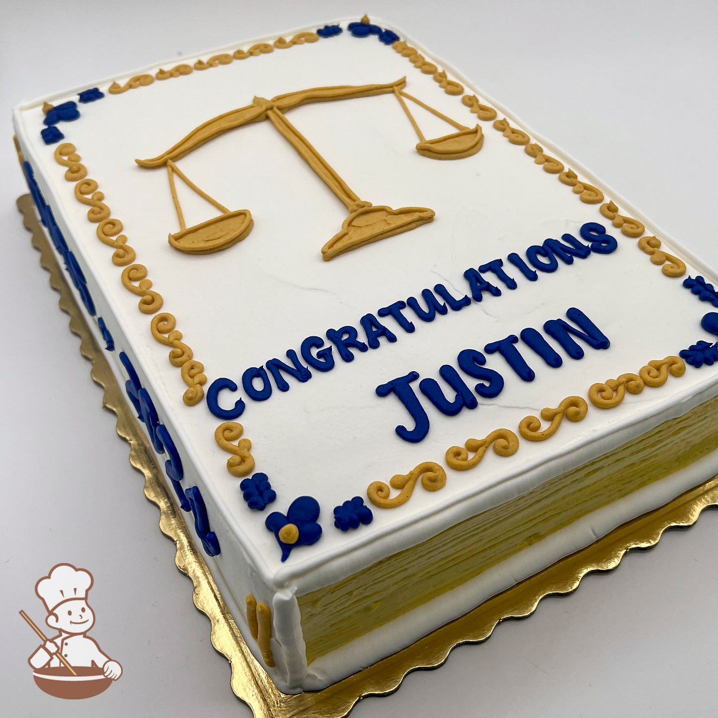 Sheet cake with buttercream scales of justice, blue and gold scroll decorations.