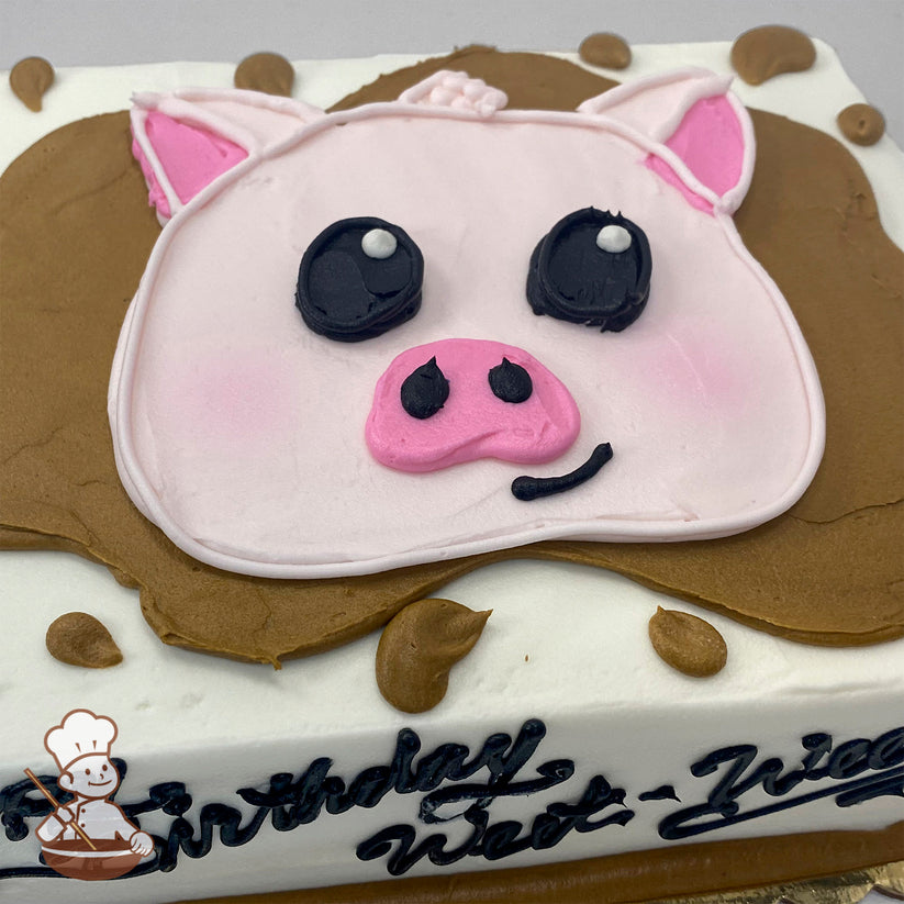 Sheet cake with a buttercream pig face decoration, featuring pink ears, black eyes, and a pink snout, surrounded by brown buttercream "mud" splashes.