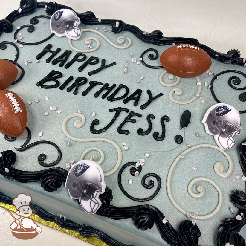 Sheet cake with light gray frosting, black and gray buttercream swirls, silver sprinkles, plastic football decorations, and Raiders helmet toppers.