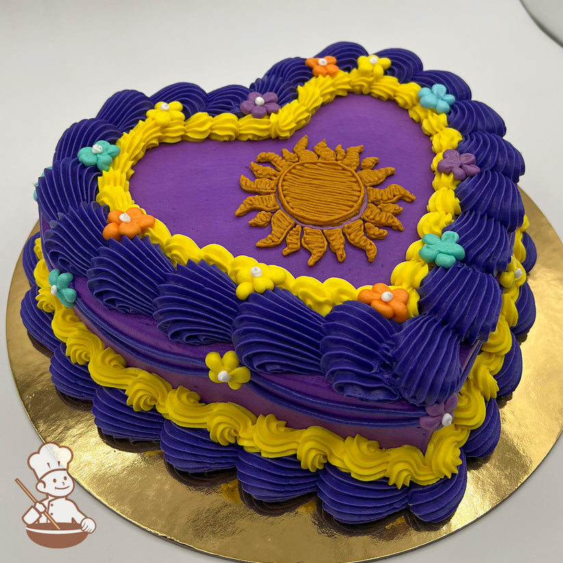 Heart-shaped purple sheet cake with yellow buttercream trim, Rapunzel's Corona sun crest in orange, and colorful buttercream flowers in blue, orange, and yellow.