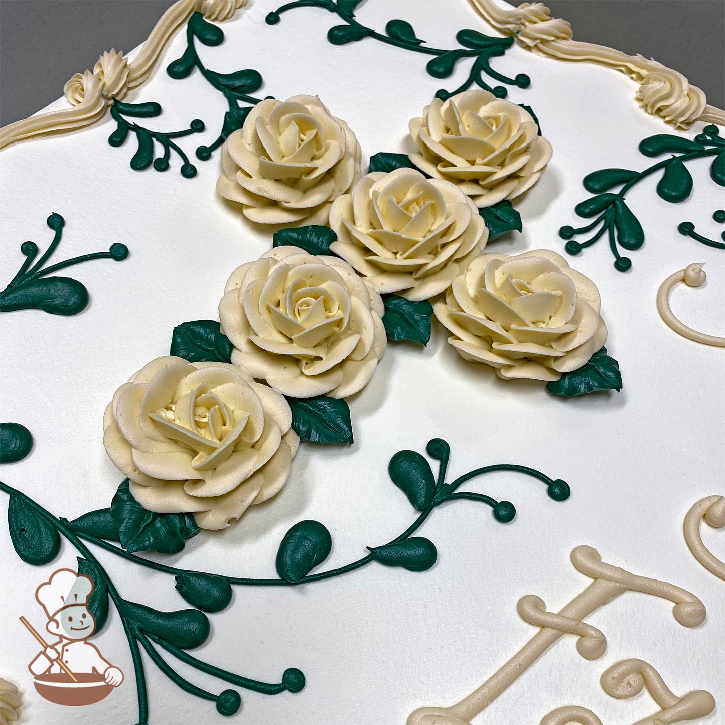 Sheet cake with buttercream decorations featuring a cross made of cream-colored roses and green leaves, surrounded by green vine designs and a cream border.