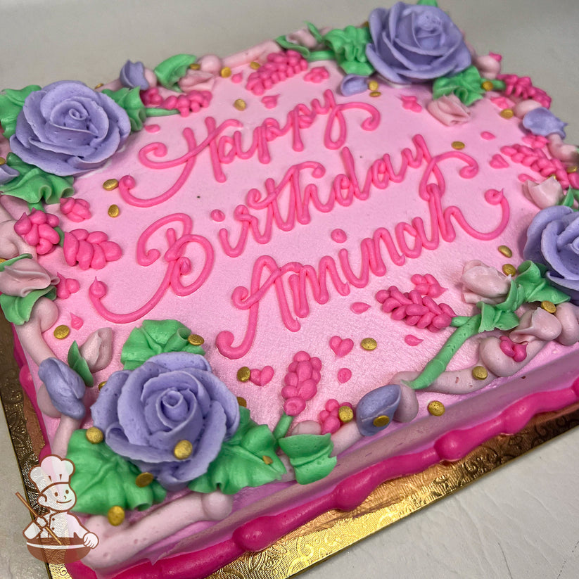 Pink sheet cake with buttercream lavender roses, pink rosebuds, green leaves, and gold sprinkles. Decorated with a pink border.
