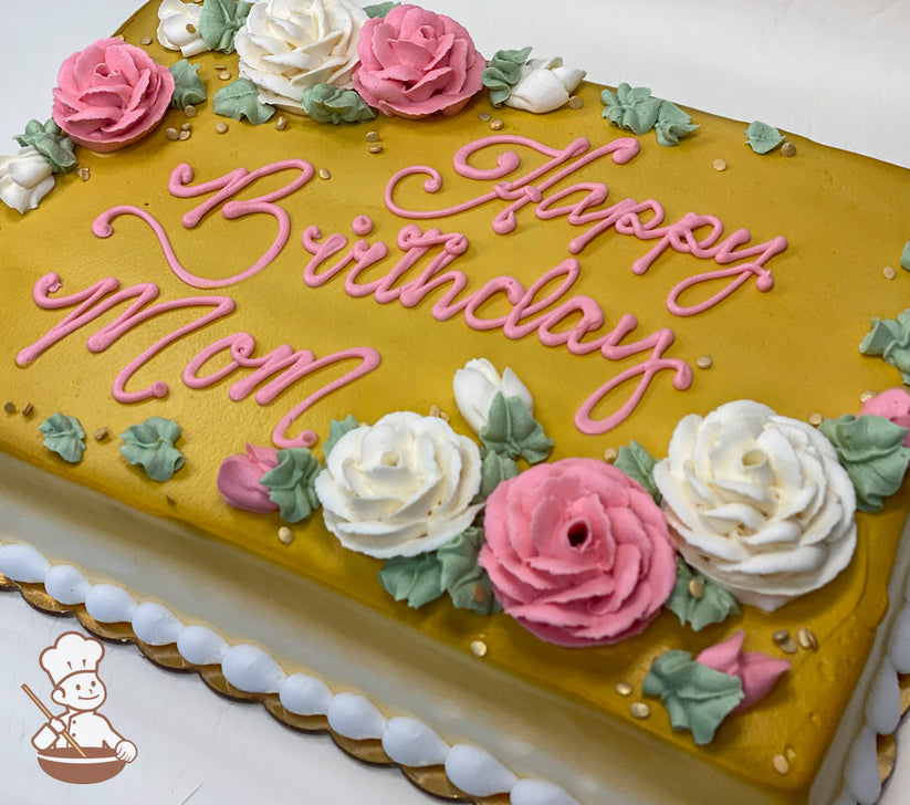 Sheet cake with golden icing, decorated with pink and white buttercream roses, green leaves, and gold sprinkles. White frosting border.