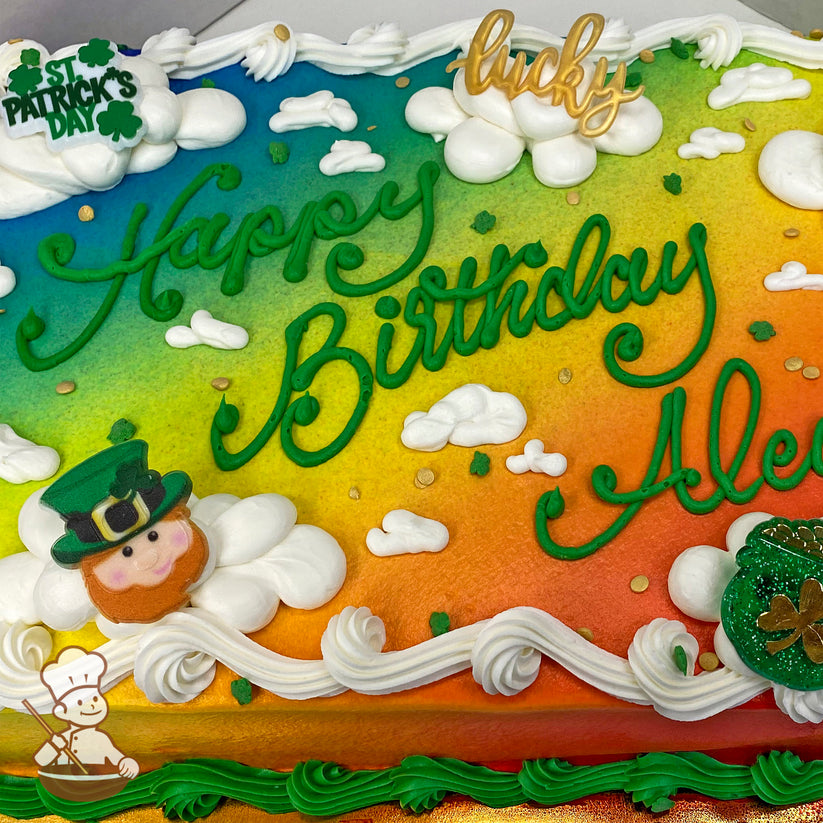 Sheet cake with a rainbow background spray, white buttercream clouds, a leprechaun face decoration, gold coins, and green shamrock accents.