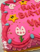 Pink sheet cake with buttercream stars, Piranha Plant decorations, and blue and pink dress trims.